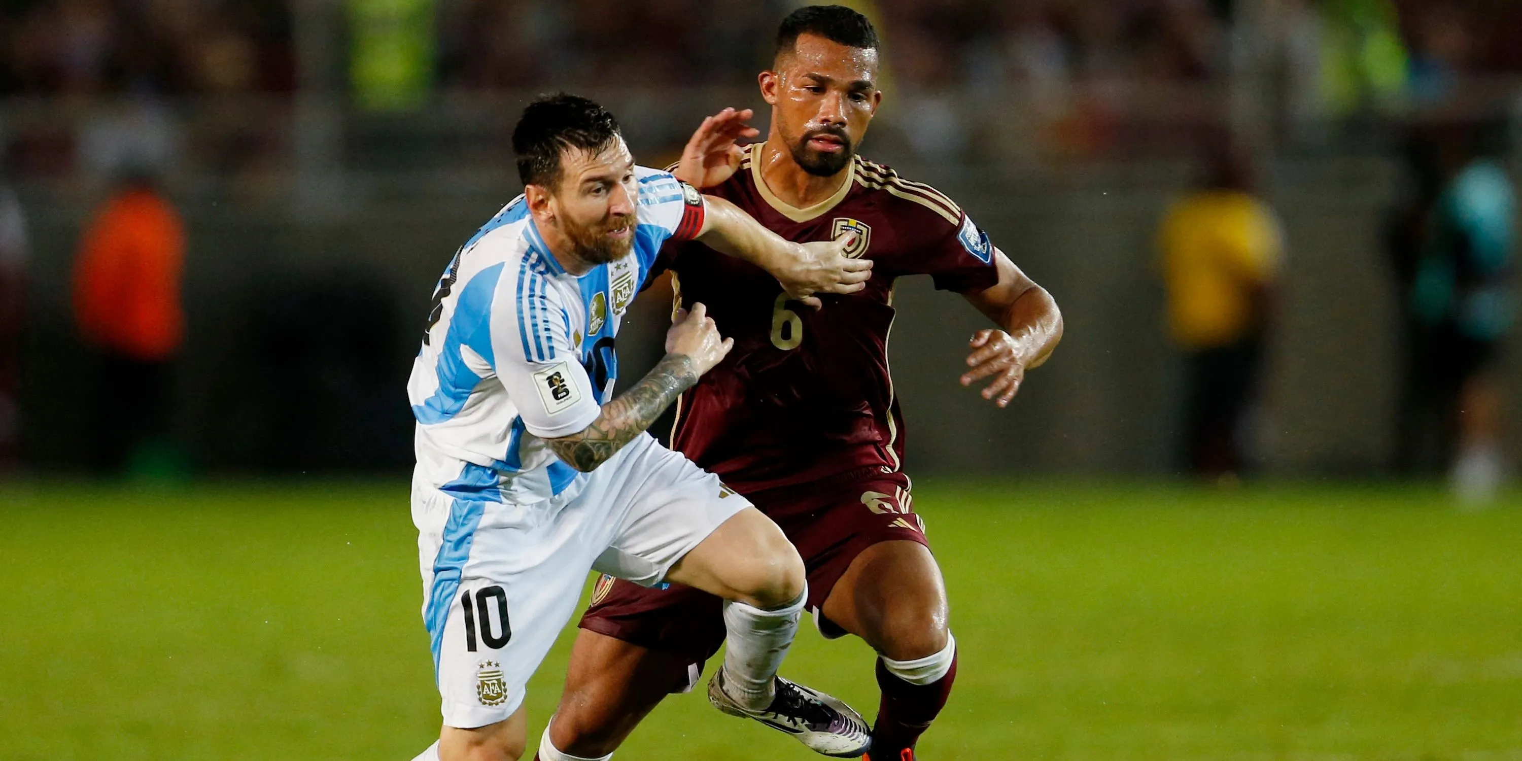 Lionel Messi của Argentina (trái) tranh bóng quyết liệt với Yangel Herrera của Venezuela (phải) trong một trận đấu quốc tế